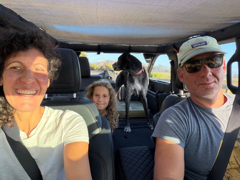 Jonathan with his family and their dog in the Jeep, top down